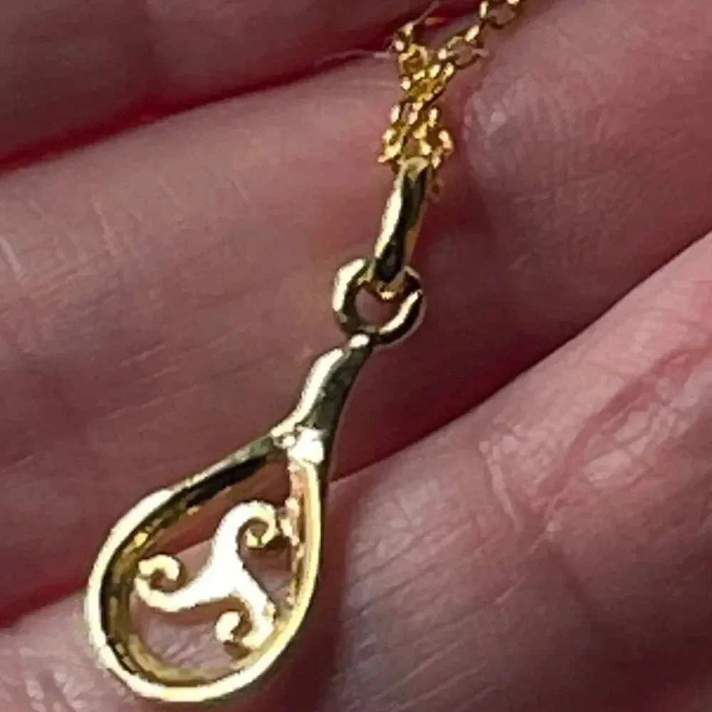 Sterling silver gold plated open work teardrop pendant and chain.